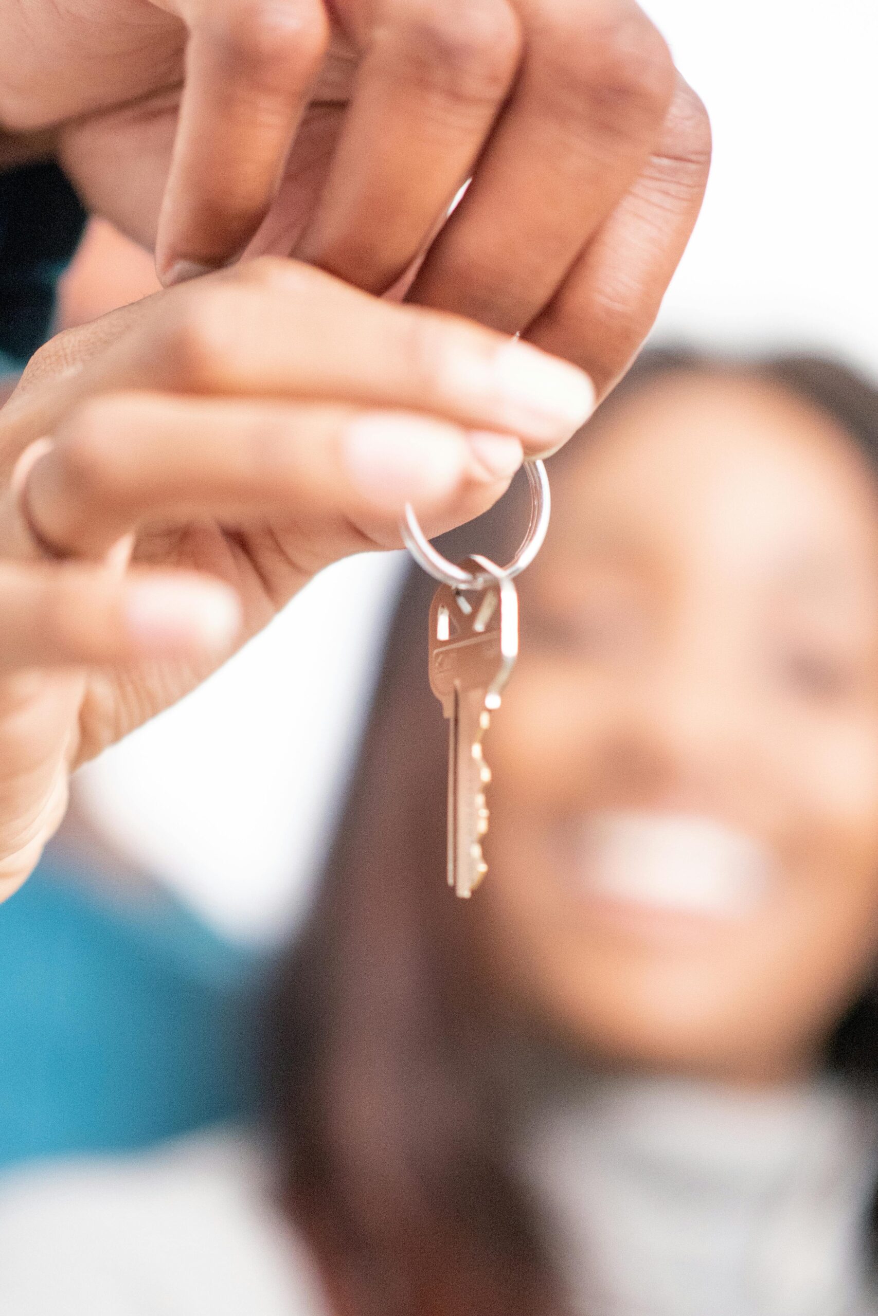 pexels-photo-7579206-7579206 Joyful moment of new homeowners receiving keys to their new house, symbolizing hope and new beginnings.